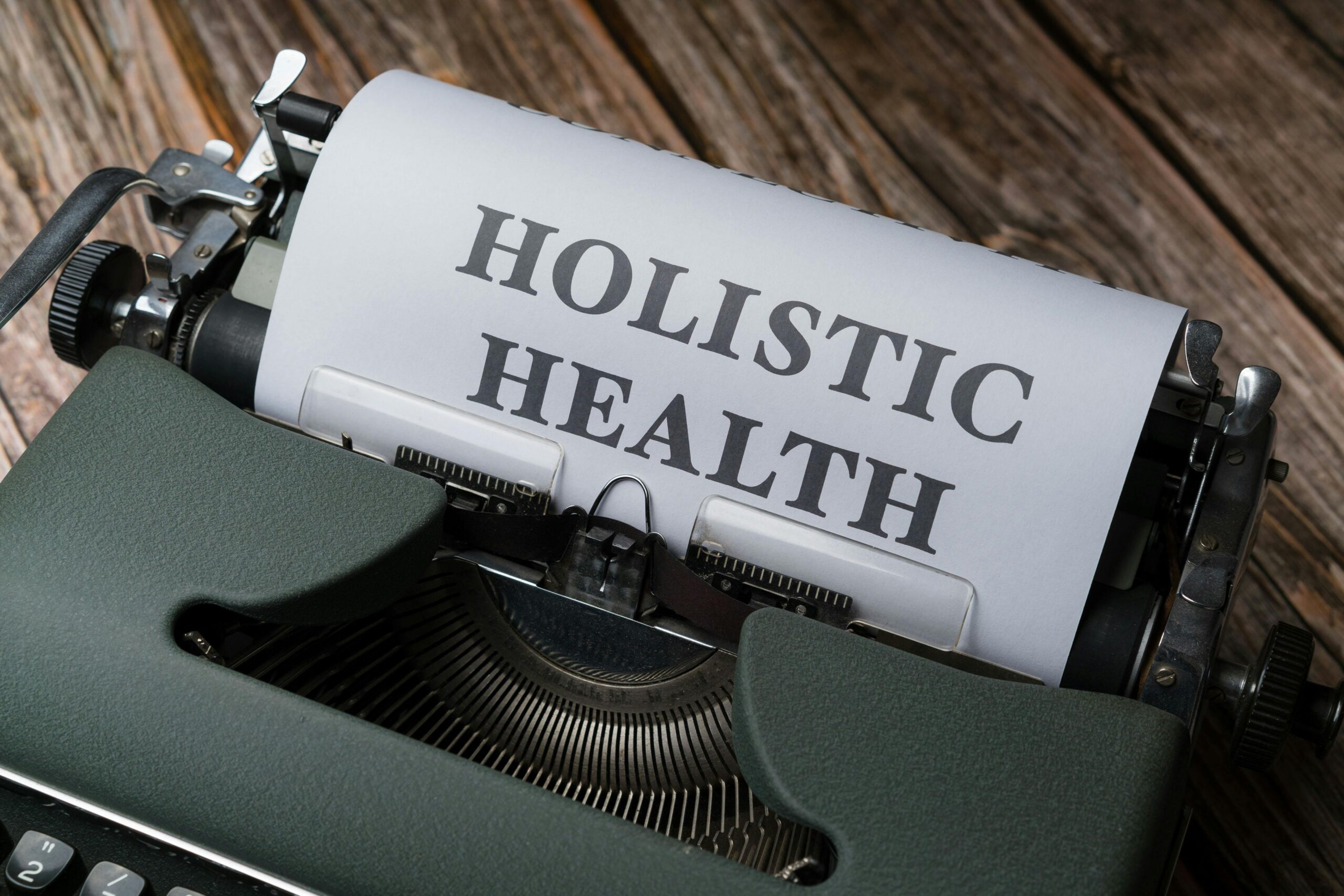 pexels-photo-18548431-18548431 Close-up of a vintage typewriter with 'Holistic Health' on paper, representing wellness.